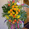 This bright and tropical funeral tribute comes delivered and set up straight