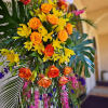 This bright and tropical funeral tribute comes delivered and set up straight