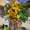 This bright and tropical funeral tribute comes delivered and set up straight