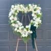 Beautifully arranged open heart in whites and greens to celebrate a loved