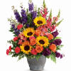 Colorful for celebration of life. A beautiful spray of sunflowers, snapdragons, larkspur
