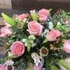 A lush bouquet featuring pink roses, elegant lilies, vibrant greenery, fragrant stock