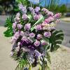 A all purple standing funeral spray designed for a memorial and funeral