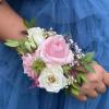 A small arrangement of beautiful flowers and greens secured to a snap
