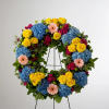 This colorful and bright wreath spray is representative of a life lived