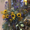 Yellow sunflowers, purple Saint Ann wildflowers, and eucalyptus create a stunning combination