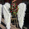 Angel Wings covered with feathers and faux flowers. Fresh red roses can