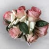 Wrist Corsage with pink spray roses and greenery on a cream bow

Colors