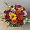Red spray roses, orange roses, yellow gerberas, red carnations, white snapdragons, pink/white