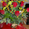 Dozen red roses with all different fillers and greens. 
