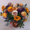 Beautiful earthy and sunny colors flowers in vase arrangment