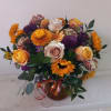 Beautiful earthy and sunny colors flowers in vase arrangment