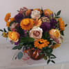 Beautiful earthy and sunny colors flowers in vase arrangment