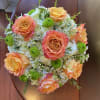 A beautifully soft design consisting of white hydrangea , orange roses 
