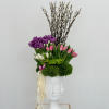 Introducing a chic vase adorned with a delightful arrangement of purple, pink