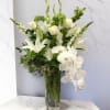Elegant arrangement of white lilies, white roses, white orchids, white snapdragons, gladiolus