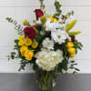 Bring the summer flowers inside with this beautiful arrangement including white hydrangeas
