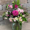 Pink roses of various shades with plenty of extras to make them