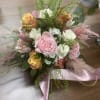 Pink and  cream roses adorned with astilbe and flowing satin ribbons