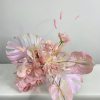 - adorned with iridescent purple and pink Anthurium leaves
- Leaves shimmer like