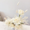 - Epitomizes elegance with a purely white composition
- Features exquisite roses, delicate