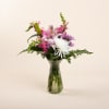 Pink lilies, white spider mums, pink snaps, lavender daisies, with leather leaf