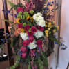 Pink snapdragons, green buttons, sunflower, peach &amp; hot pink roses, yellow spray
