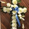 White mums with white calla lilies on a cross with a blue