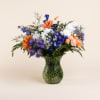Peach gerberas, white daisies, iris, peach mini carnations delphinium and purple Monte