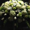 A mixture of white and green hydrangeas accented with seasonal flowers.