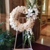 standing spray of white roses accented with phalaenopsis orchids