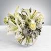 This arrangement includes white roses, white asiatic lilies, white stock, and dusty