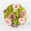 This vintage style arrangement contains roses, hydrangea, and a succulent. It is