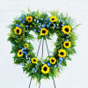 This beautiful heart-shaped wreath filled with sunflowers, Solidago and Blue Delphinium is