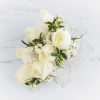 A classic white corsage with silver sheer ribbon, this wrist arrangement looks