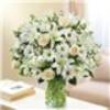 Express your sincere condolences with our elegant all-white arrangement of roses, lilies