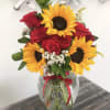 Beautiful red roses, sunflowers a touch of babies breath with greenery in