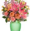 Brighten any day with blushing blooms, cheerfully presented in a glass vase