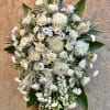 Beautiful spray arrangement featuring white roses, lilies, chrsanthemums, delphinium, daisies, and green