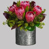 Pink mink proteas are arranged with seeded eucalyptus, plus galax and ti