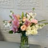 A vase arrangement adorned with majestic lilies, delicate pink roses, and fragrant