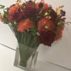 Lush assortment of long stemmed flowers set in a cluster of steel