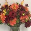 Lush assortment of long stemmed flowers set in a cluster of steel