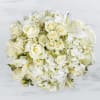 Fresh floral arrangement in a cube vase.