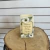 A battery operated real wax candle.

Text reads &quot;Time passes, memories stay, loved