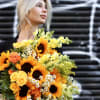 Sunny bouquet of sunflowers and different flowers