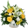 A serene white and yellow arrangement of lilies, miniature carnations, daisies and