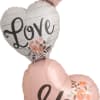 &quot;I Love Us&quot;&#039; mylar balloon on three stacked hearts. 48&quot; tall.