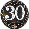A black standard-sized mylar with gold and white polka dots around the
