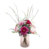 This floral arrangement features a beautiful mix of pink and magenta flowers